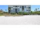 Beachfront condominium with beach access, featuring multiple floors and balconies overlooking pristine white sands at 2675 Gulf Of Mexico Dr # 403, Longboat Key, FL 34228