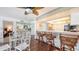 Bright dining area features a glass table, unique chairs and accents, and access to the kitchen at 2675 Gulf Of Mexico Dr # 403, Longboat Key, FL 34228