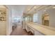 Bright Dressing area with lots of mirrors and vanity space, leading to the bedroom and closet at 2675 Gulf Of Mexico Dr # 403, Longboat Key, FL 34228
