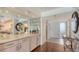 Entryway bar with storage cabinets, glassware, mirror, and an ocean view at 2675 Gulf Of Mexico Dr # 403, Longboat Key, FL 34228