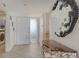 Foyer with tile flooring, seashell table, decorative mirror, washer, and dryer at 2675 Gulf Of Mexico Dr # 403, Longboat Key, FL 34228