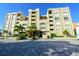 Beautiful condominium building with palm trees and brick-paved parking at 2675 Gulf Of Mexico Dr # 403, Longboat Key, FL 34228