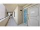 Condo hallway with neutral walls, tile flooring, and a decorative glass front door at 2675 Gulf Of Mexico Dr # 403, Longboat Key, FL 34228