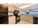 Bright kitchen features stainless steel appliances and beige cabinets with granite countertops and a view at 2675 Gulf Of Mexico Dr # 403, Longboat Key, FL 34228