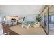 Living room featuring hardwood floors, a sectional sofa, and a dining area at 2675 Gulf Of Mexico Dr # 403, Longboat Key, FL 34228