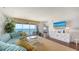 Living room showcasing a sectional sofa, TV, large windows, and an ocean view at 2675 Gulf Of Mexico Dr # 403, Longboat Key, FL 34228