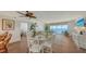 Open-concept living and dining space with stunning ocean views from the large windows and balcony at 2675 Gulf Of Mexico Dr # 403, Longboat Key, FL 34228