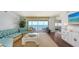 Living room showcasing a sectional sofa, TV, large windows, and an ocean view at 2675 Gulf Of Mexico Dr # 403, Longboat Key, FL 34228