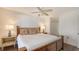 Comfortable main bedroom featuring a bamboo bed frame, ceiling fan, and side tables with lamps at 2675 Gulf Of Mexico Dr # 403, Longboat Key, FL 34228