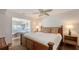 Relaxing main bedroom features a ceiling fan, a bamboo bed frame, and an adjacent sitting area at 2675 Gulf Of Mexico Dr # 403, Longboat Key, FL 34228