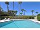 Condo pool with green landscape and palm trees at 2675 Gulf Of Mexico Dr # 403, Longboat Key, FL 34228