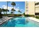 Inviting turquoise pool surrounded by lush tropical landscaping and comfortable lounge chairs, near the condo building at 2675 Gulf Of Mexico Dr # 403, Longboat Key, FL 34228