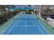 Aerial view of condo tennis court with lush green landscape at 2675 Gulf Of Mexico Dr # 403, Longboat Key, FL 34228