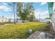 Spacious backyard with lush grass, shade trees, and a partial view of the neighboring houses at 270 E Langsner St, Englewood, FL 34223