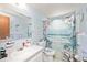 Bright bathroom with blue accents, beach-themed shower curtain, and decorative touches at 270 E Langsner St, Englewood, FL 34223