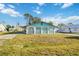 View of the home's arched entry showing the front exterior with large yard and driveway at 270 E Langsner St, Englewood, FL 34223