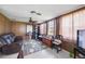 Cozy Gathering room with paneled walls, a ceiling fan, and comfortable seating at 270 E Langsner St, Englewood, FL 34223