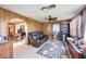 Inviting living room featuring wood paneling, tile floors, and a comfortable leather sofa at 270 E Langsner St, Englewood, FL 34223