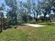 Lush backyard with mature trees and a defined patio space, ideal for outdoor activities and relaxation at 2816 N Lockwood Meadows Blvd, Sarasota, FL 34234