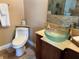 Bathroom features a modern glass sink, toilet, and stone accents at 2816 N Lockwood Meadows Blvd, Sarasota, FL 34234