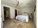 Bedroom featuring tile floors, a ceiling fan, closet, and an adjoining bathroom at 2816 N Lockwood Meadows Blvd, Sarasota, FL 34234