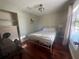 Bright bedroom with hardwood floors, a comfortable bed, and a large window letting in ample natural light at 2816 N Lockwood Meadows Blvd, Sarasota, FL 34234