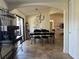 Open dining room flows into a living area, complete with large windows, sleek furniture, and stone tile flooring at 2816 N Lockwood Meadows Blvd, Sarasota, FL 34234