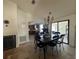 Open-concept dining area with a chandelier, seamlessly flowing into the kitchen and screened-in outdoor area at 2816 N Lockwood Meadows Blvd, Sarasota, FL 34234