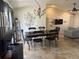 Elegant dining area with a stone accent wall, chandelier lighting, and seamless access to the living space at 2816 N Lockwood Meadows Blvd, Sarasota, FL 34234