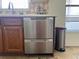 Stainless steel dishwasher complemented by oak cabinetry and a stainless steel trash can at 2816 N Lockwood Meadows Blvd, Sarasota, FL 34234