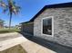 Beautiful home exterior with stone accents, a well-maintained lawn, and a modern garage door at 2816 N Lockwood Meadows Blvd, Sarasota, FL 34234