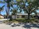 Charming single-story home with a two-car garage and a wide driveway, shaded by mature trees at 2816 N Lockwood Meadows Blvd, Sarasota, FL 34234
