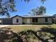 Charming single-story home with a two-car garage, stone accents, and a well-manicured lawn at 2816 N Lockwood Meadows Blvd, Sarasota, FL 34234