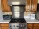 Kitchen with stainless steel range and hood, white counters and custom wood cabinets at 2816 N Lockwood Meadows Blvd, Sarasota, FL 34234