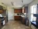 Functional kitchen with stainless steel appliances, tile floors, and wood cabinets at 2816 N Lockwood Meadows Blvd, Sarasota, FL 34234