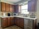 Well-lit kitchen features oak cabinets, stainless steel dishwasher, and white countertops at 2816 N Lockwood Meadows Blvd, Sarasota, FL 34234