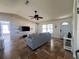 Cozy living room with exposed brick wall, travertine floors, a ceiling fan, and natural light at 2816 N Lockwood Meadows Blvd, Sarasota, FL 34234