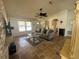 Open-concept living room features travertine floors, vaulted ceilings, and plenty of natural light at 2816 N Lockwood Meadows Blvd, Sarasota, FL 34234