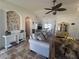 Open concept living room with vaulted ceilings, travertine floors, and access to dining area at 2816 N Lockwood Meadows Blvd, Sarasota, FL 34234