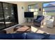 Bright sunroom featuring tile floors, large windows, comfortable wicker furniture, and a sliding door to the outside at 2816 N Lockwood Meadows Blvd, Sarasota, FL 34234