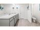 Bright bathroom with a double sink vanity, tiled floors, and stylish mermaid-themed decor at 3027 Great Abaco Way, Bradenton, FL 34208