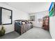 Bright bedroom with a comfortable futon, decorative pillows, and a stylish display cabinet at 3027 Great Abaco Way, Bradenton, FL 34208