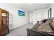 Well lit bedroom with a futon, display cabinet, television, and neutral walls at 3027 Great Abaco Way, Bradenton, FL 34208
