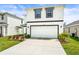 Charming two-story home featuring a clean white exterior and well-manicured lawn, plus a two car garage at 3027 Great Abaco Way, Bradenton, FL 34208