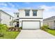 Charming two-story home featuring a clean white exterior and well-manicured lawn, plus a two car garage at 3027 Great Abaco Way, Bradenton, FL 34208