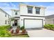 Charming two-story home featuring a clean white exterior and well-manicured lawn, plus a two car garage at 3027 Great Abaco Way, Bradenton, FL 34208