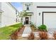 Inviting front porch with a decorative wreath, 'Welcome' sign, and potted plants enhancing its curb appeal at 3027 Great Abaco Way, Bradenton, FL 34208