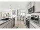 A spacious kitchen with stainless appliances, and a breakfast bar overlooks the living area at 3027 Great Abaco Way, Bradenton, FL 34208