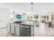 An open kitchen with gray cabinets and views of the living and dining areas at 3027 Great Abaco Way, Bradenton, FL 34208