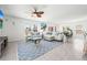Bright living room featuring a comfortable seating arrangement, stylish rug, and plenty of natural light at 3027 Great Abaco Way, Bradenton, FL 34208